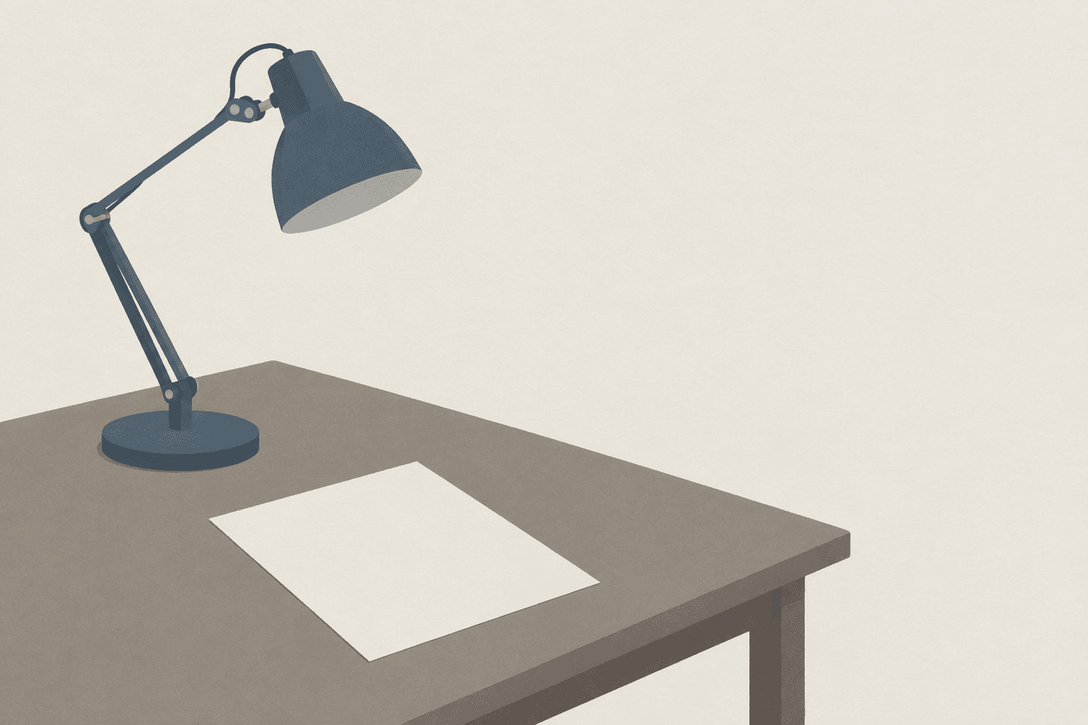 The corner of a bare desk with a plain angle-poise lamp switched off, and one blank sheet of paper beside it.