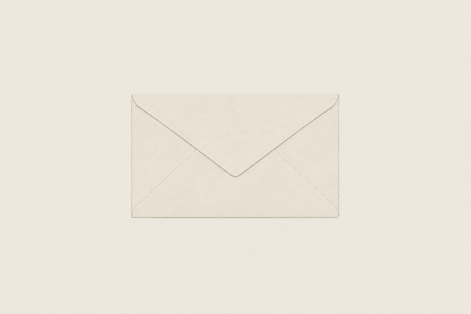 A single plain unsealed envelope lying flat and closed on an empty pale surface.