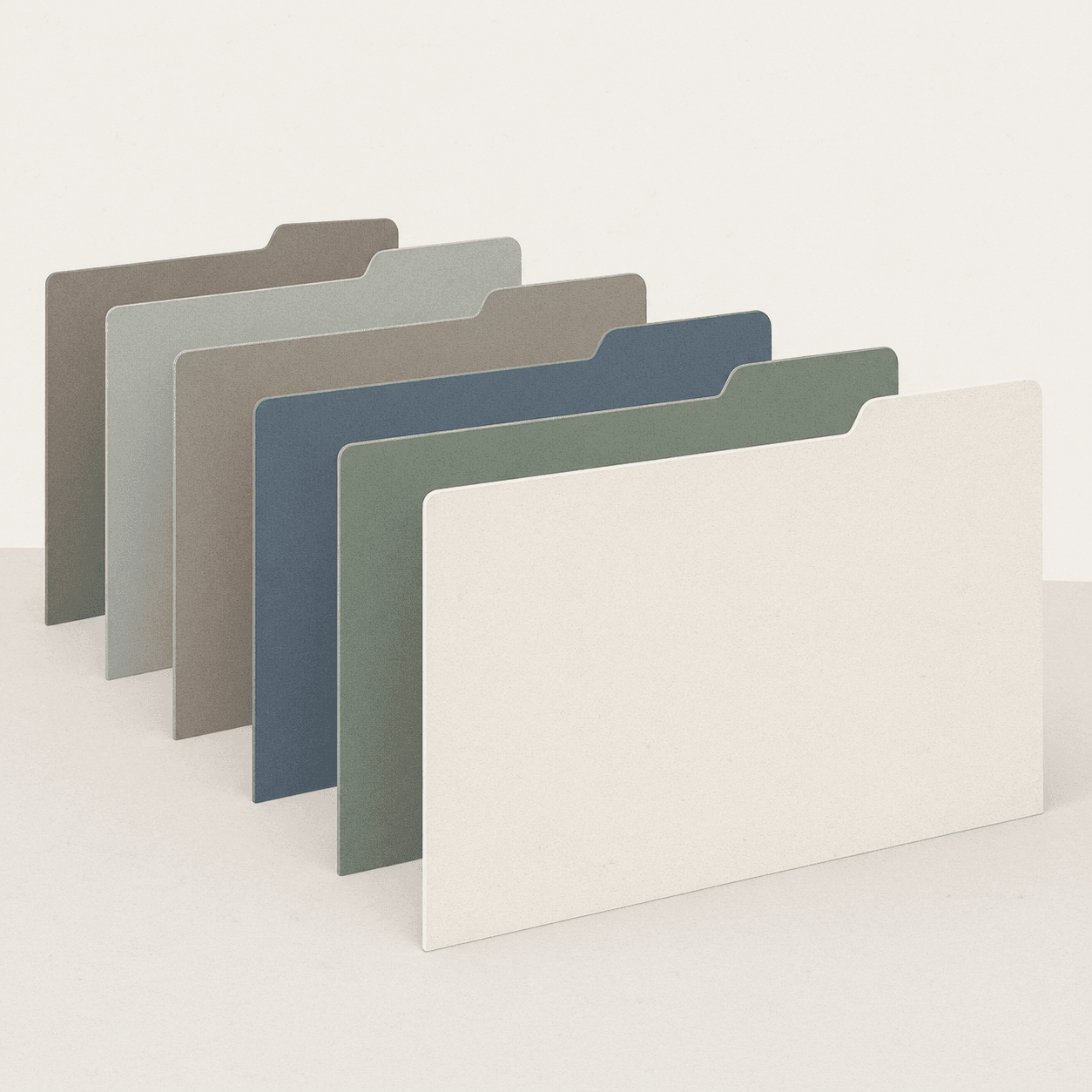 A row of plain card file dividers with blank tabs, standing upright and evenly spaced.