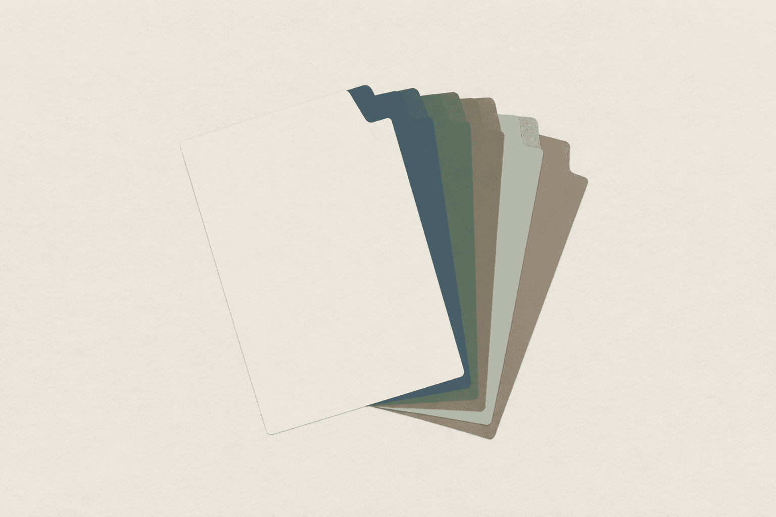 A plain set of card dividers fanned out flat on a surface, each tab blank, seen from above.