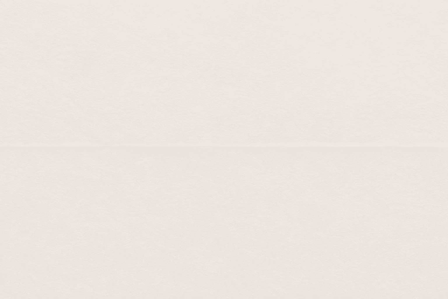 A large plain sheet of blank paper with one soft crease across it, seen flat from above.